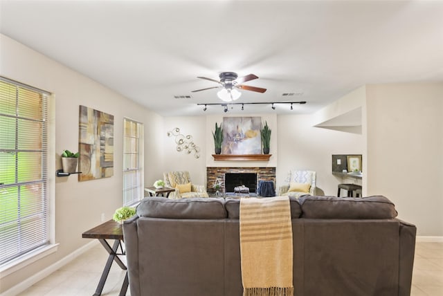2151 Middle Creek Dr, Houston, TX 77339 - living area featuring track lighting, a ceiling fan, a fireplace, and light tile patterned floors