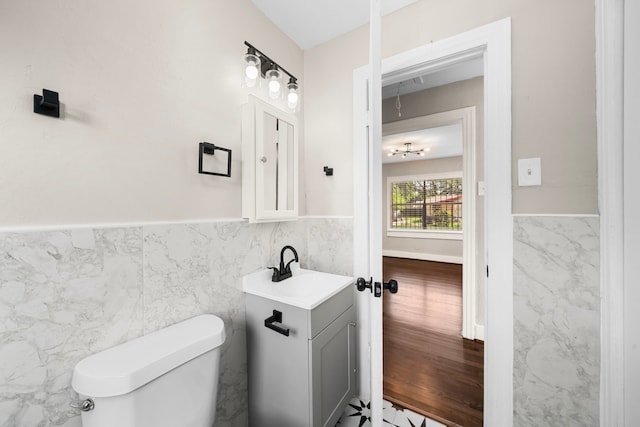 5519 Chapman St, Houston, TX 77009 - bathroom featuring tile walls, vanity, and a wainscoted wall