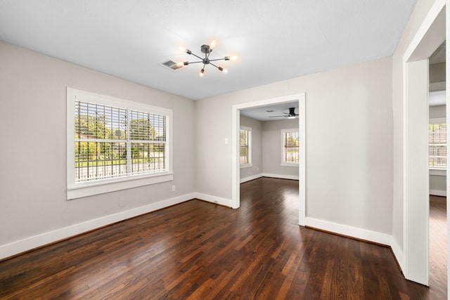5519 Chapman St, Houston, TX 77009 - unfurnished dining area with a chandelier and dark wood-type flooring