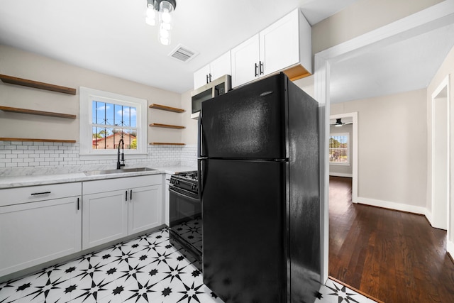 5519 Chapman St, Houston, TX 77009 - kitchen with black appliances, open shelves, plenty of natural light, and tasteful backsplash