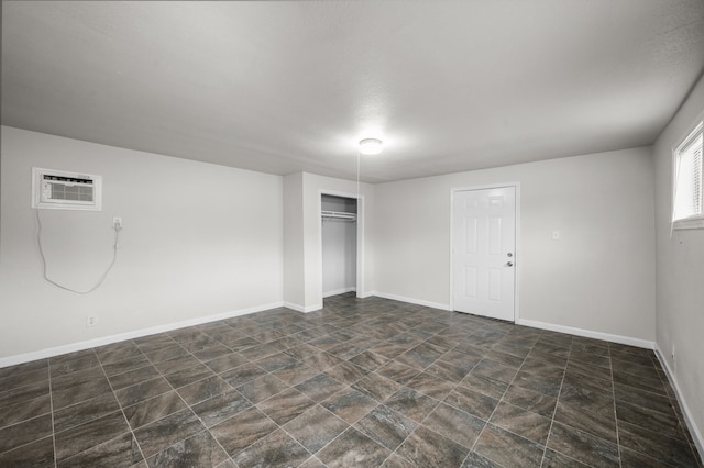 5519 Chapman St, Houston, TX 77009 - unfurnished bedroom with a wall mounted air conditioner, a closet, and stone finish floors