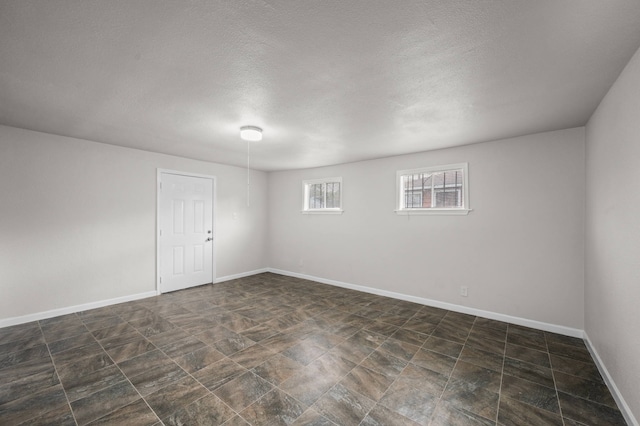 5519 Chapman St, Houston, TX 77009 - spare room with baseboards and a textured ceiling