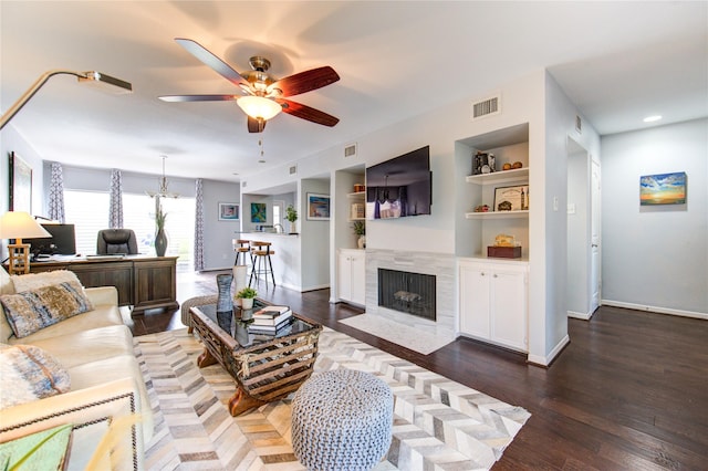 1964 Augusta Dr, Houston, TX 77057 - living room featuring a ceiling fan, an office area, a tile fireplace, wood finished floors, and built in shelves