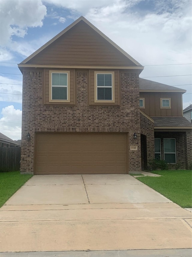 15318 Laceleaf Trl, Houston, TX 77044 - view of front facade with brick siding, a garage, concrete driveway, a front lawn, and board and batten siding