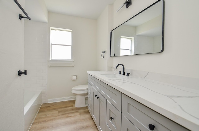 10623 Longmont Dr, Houston, TX 77042 - full bath featuring vanity, wood finished floors, and washtub / shower combination