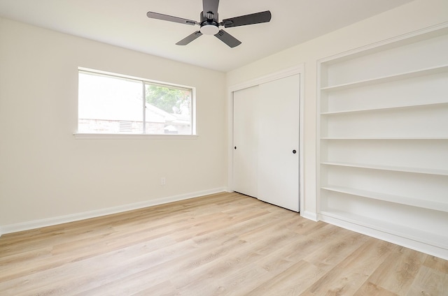 10623 Longmont Dr, Houston, TX 77042 - unfurnished bedroom with light wood finished floors and ceiling fan