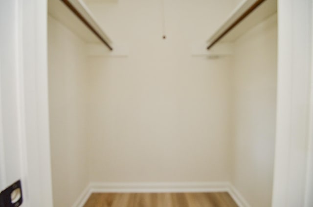 10623 Longmont Dr, Houston, TX 77042 - walk in closet featuring wood finished floors