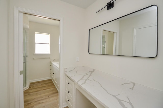 10623 Longmont Dr, Houston, TX 77042 - bathroom featuring vanity, wood finished floors, and a stall shower