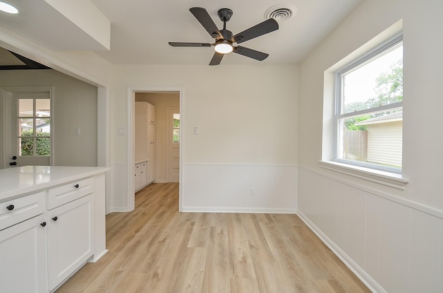 10623 Longmont Dr, Houston, TX 77042 - spare room with light wood finished floors, a wainscoted wall, and ceiling fan
