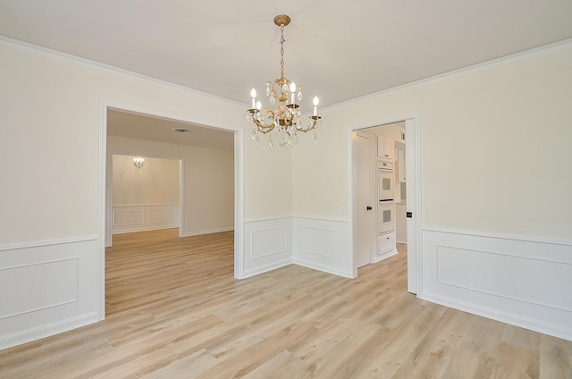 10623 Longmont Dr, Houston, TX 77042 - unfurnished room featuring a chandelier, a decorative wall, ornamental molding, wainscoting, and light wood finished floors