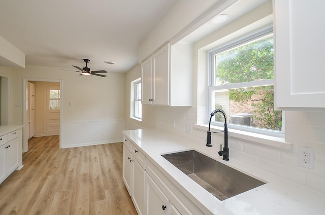 10623 Longmont Dr, Houston, TX 77042 - kitchen featuring healthy amount of natural light, backsplash, and white cabinetry