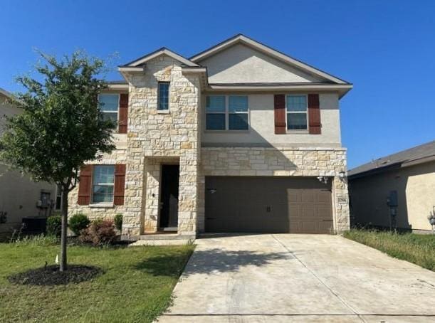 12906 Awuzie Trl, San Antonio, TX 78254 - view of front of property with stone siding, driveway, an attached garage, and a front yard