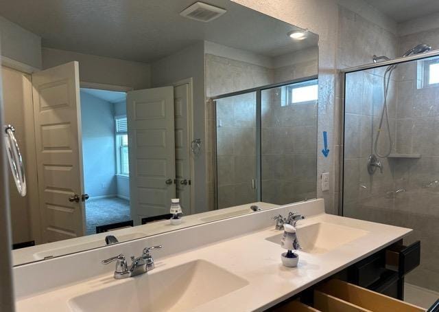 12906 Awuzie Trl, San Antonio, TX 78254 - bathroom featuring double vanity and a shower stall