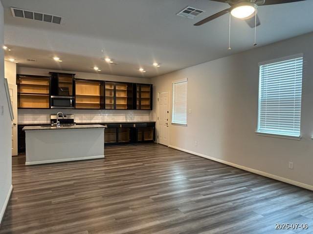 12906 Awuzie Trl, San Antonio, TX 78254 - kitchen with stainless steel microwave, open shelves, dark wood-type flooring, dark countertops, and recessed lighting