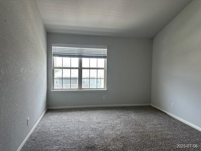 12906 Awuzie Trl, San Antonio, TX 78254 - carpeted spare room featuring a textured wall and baseboards