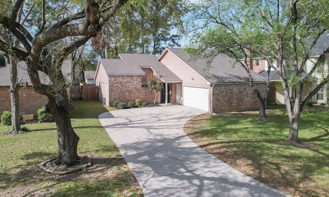 22635 River Birch Dr, Tomball, TX 77375 - view of front of home with brick siding, driveway, an attached garage, and roof with shingles