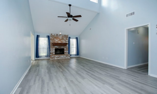22635 River Birch Dr, Tomball, TX 77375 - unfurnished living room with high vaulted ceiling, ceiling fan, wood finished floors, and a brick fireplace