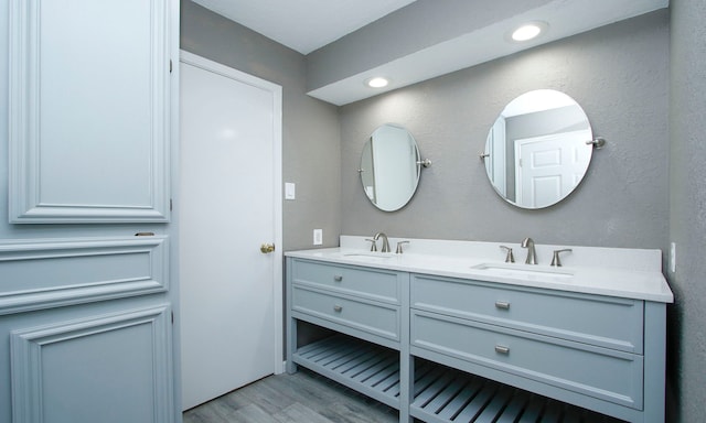 22635 River Birch Dr, Tomball, TX 77375 - bathroom featuring double vanity and wood finished floors