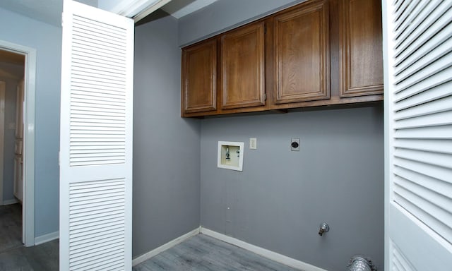 22635 River Birch Dr, Tomball, TX 77375 - laundry area with wood finished floors, electric dryer hookup, washer hookup, and cabinet space