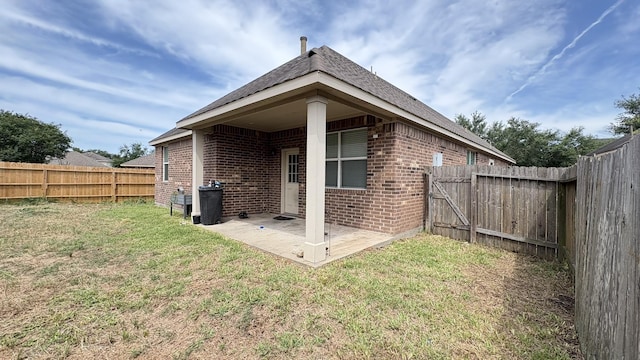 20530 Keegans Ledge Ln, Cypress, TX 77433 - rear view of house featuring brick siding, a fenced backyard, and a patio
