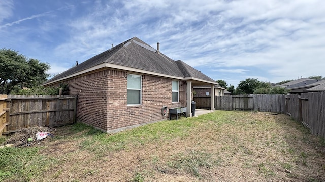 20530 Keegans Ledge Ln, Cypress, TX 77433 - rear view of house featuring brick siding, a fenced backyard, and roof with shingles