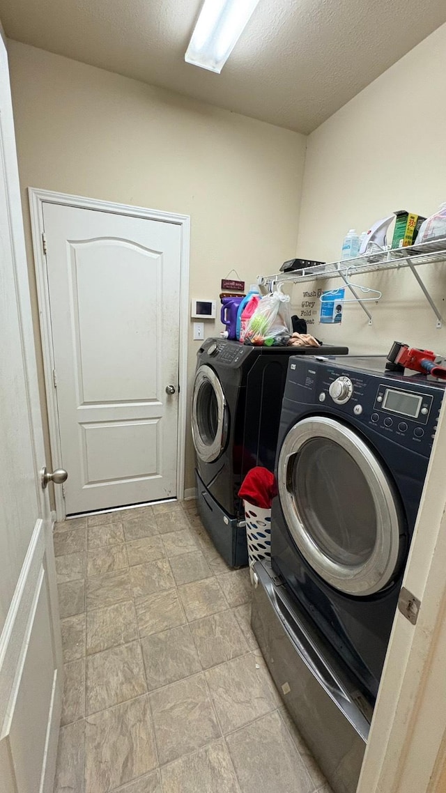 20530 Keegans Ledge Ln, Cypress, TX 77433 - laundry area featuring washing machine and clothes dryer and stone finish flooring