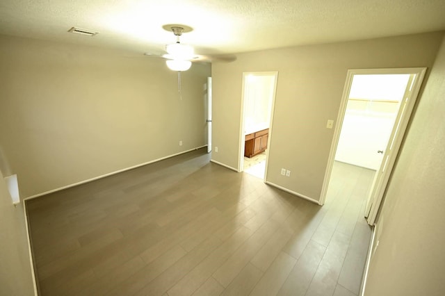18927 Remington Bend Dr, Houston, TX 77073 - spare room featuring a ceiling fan, dark wood-style floors, and a textured ceiling