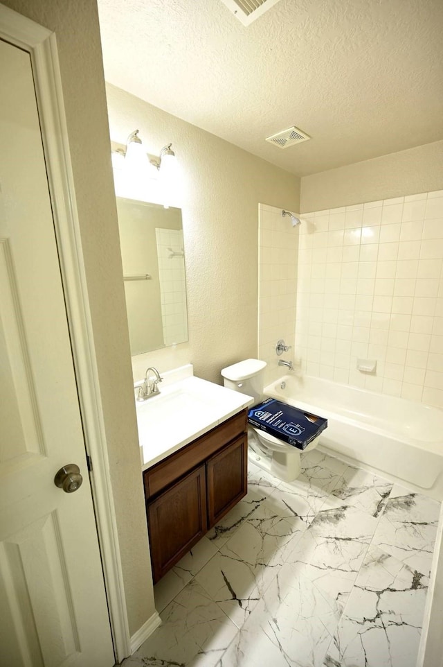 18927 Remington Bend Dr, Houston, TX 77073 - bathroom featuring vanity, a textured wall, a textured ceiling, shower / bathtub combination, and marble look tiles