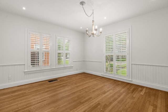 2409 Dryden Rd, Houston, TX 77030 - unfurnished room featuring a chandelier, wood finished floors, wainscoting, and ornamental molding
