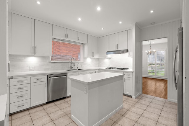 2409 Dryden Rd, Houston, TX 77030 - kitchen with appliances with stainless steel finishes, under cabinet range hood, white cabinetry, light tile patterned floors, and light countertops