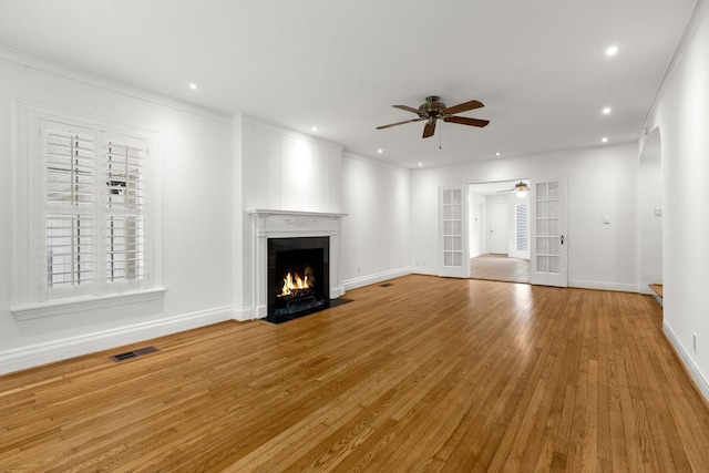 2409 Dryden Rd, Houston, TX 77030 - unfurnished living room with ceiling fan, a fireplace with flush hearth, wood finished floors, recessed lighting, and ornamental molding