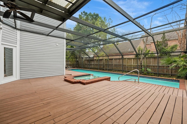 2409 Dryden Rd, Houston, TX 77030 - view of swimming pool featuring a deck, a fenced backyard, glass enclosure, and a pool with connected hot tub