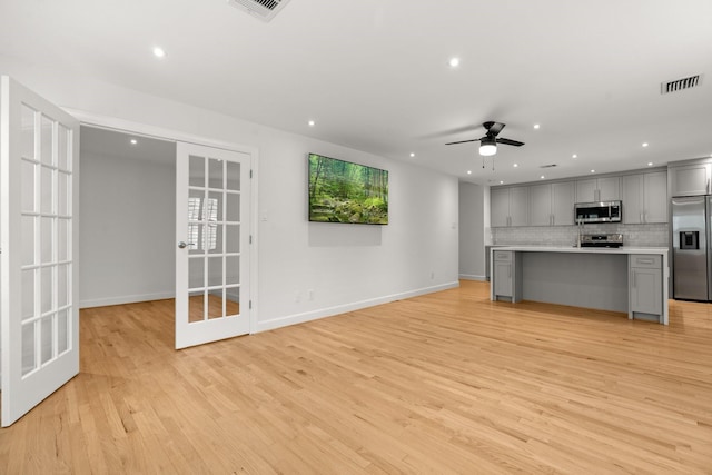 2409 Dryden Rd, Houston, TX 77030 - unfurnished living room with french doors, recessed lighting, ceiling fan, and light wood-style flooring