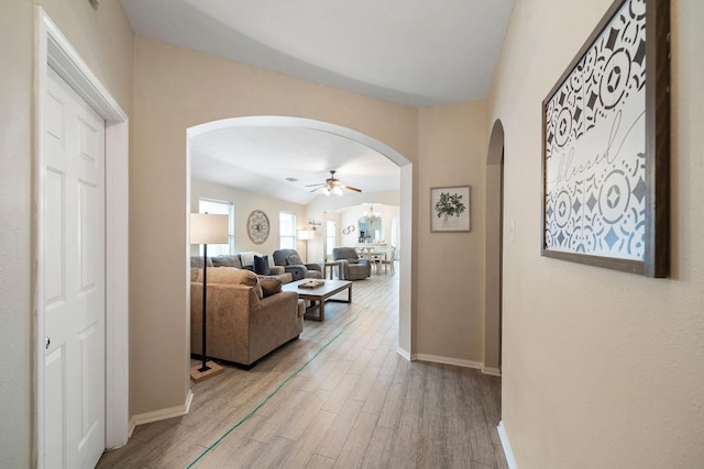 3261 Gladewater Ln, League City, TX 77573 - hall with arched walkways and light wood-style floors