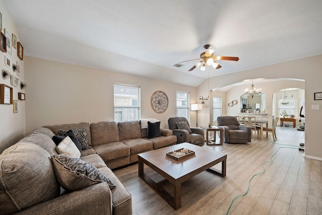 3261 Gladewater Ln, League City, TX 77573 - living room with arched walkways, a chandelier, a ceiling fan, and light wood-style flooring