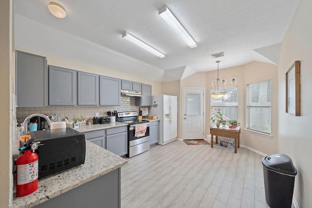 3261 Gladewater Ln, League City, TX 77573 - kitchen featuring electric range, white refrigerator with ice dispenser, gray cabinetry, lofted ceiling, and backsplash