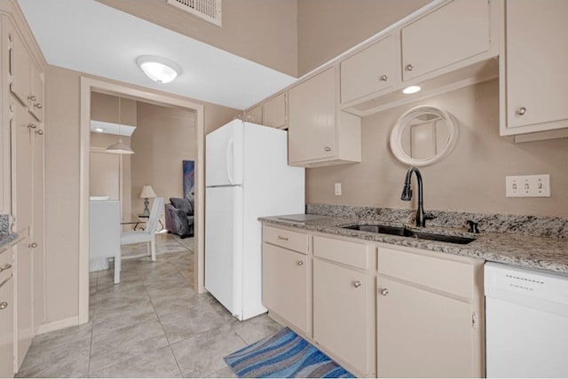 9809 Richmond Ave Unit 8, Houston, TX 77042 - kitchen featuring white appliances, light tile patterned floors, and light stone counters