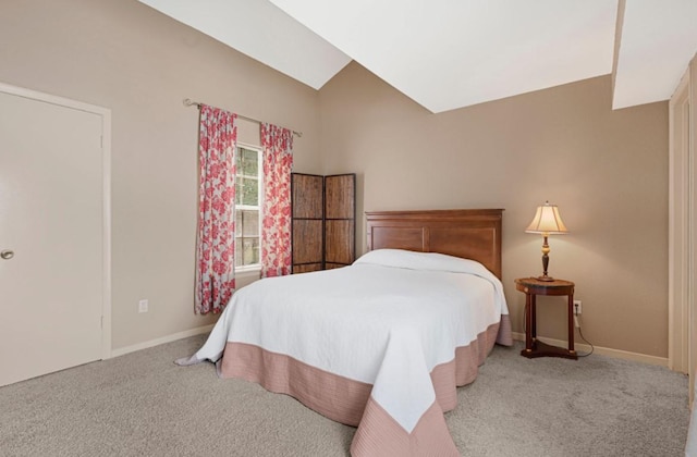 9809 Richmond Ave Unit 8, Houston, TX 77042 - carpeted bedroom with baseboards and vaulted ceiling