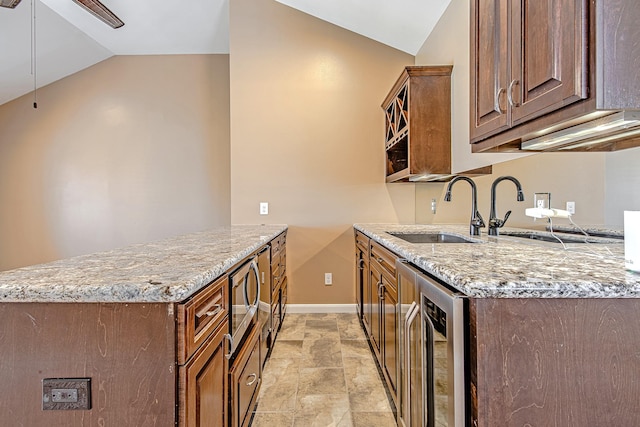 2315 Huldy St, Houston, TX 77019 - kitchen featuring vaulted ceiling, stainless steel microwave, light stone countertops, beverage cooler, and light stone finish floors