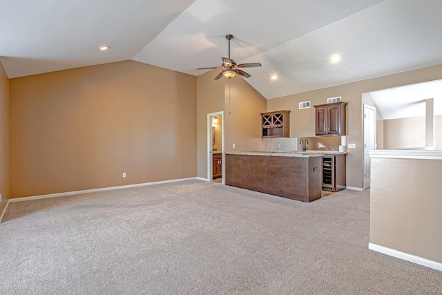 2315 Huldy St, Houston, TX 77019 - kitchen featuring beverage cooler, light colored carpet, lofted ceiling, ceiling fan, and open floor plan