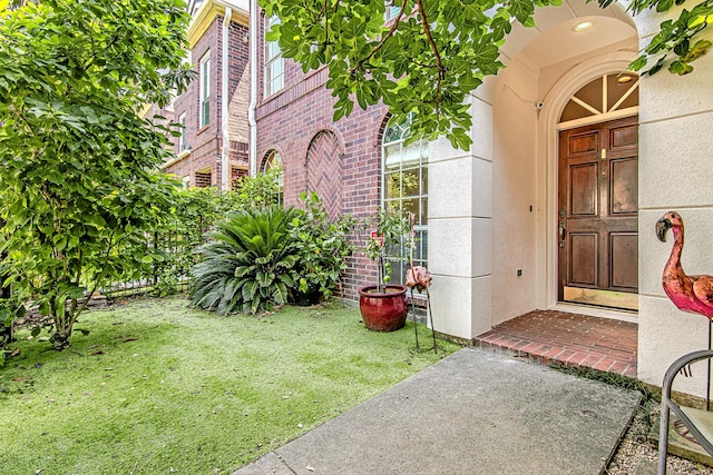2315 Huldy St, Houston, TX 77019 - doorway to property featuring brick siding and a yard