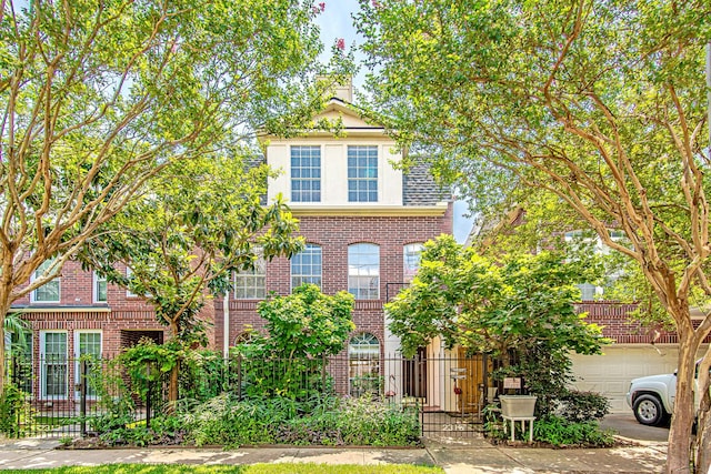 2315 Huldy St, Houston, TX 77019 - view of front of house with brick siding, a garage, and driveway