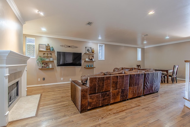 2315 Huldy St, Houston, TX 77019 - living room featuring light wood-style flooring, ornamental molding, a tiled fireplace, and recessed lighting