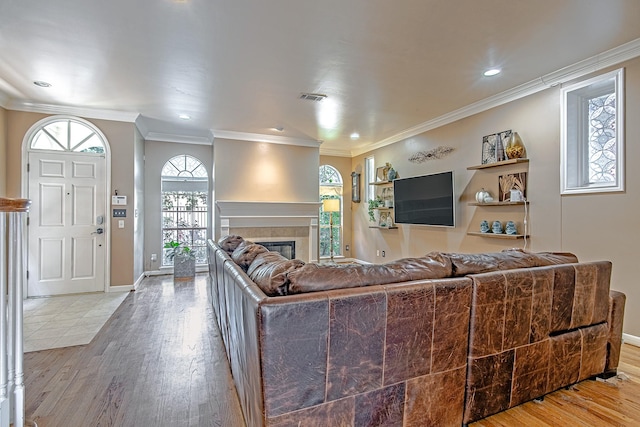 2315 Huldy St, Houston, TX 77019 - living area featuring wood finished floors, a tiled fireplace, plenty of natural light, crown molding, and recessed lighting