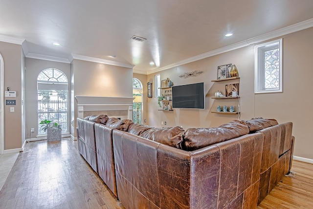 2315 Huldy St, Houston, TX 77019 - living room with light wood-type flooring, a tiled fireplace, ornamental molding, healthy amount of natural light, and recessed lighting