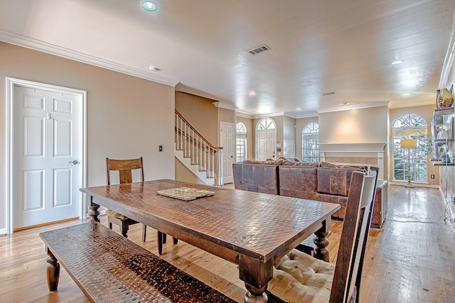 2315 Huldy St, Houston, TX 77019 - dining room featuring stairway, ornamental molding, light wood-type flooring, and recessed lighting