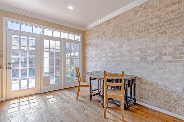 2315 Huldy St, Houston, TX 77019 - dining space featuring crown molding, brick wall, wood finished floors, and healthy amount of natural light