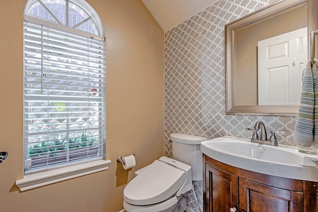2315 Huldy St, Houston, TX 77019 - bathroom featuring lofted ceiling, vanity, and wallpapered walls