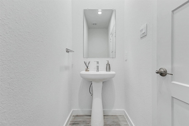3368 Voda Bend Dr, Katy, TX 77493 - bathroom featuring a textured wall and wood finished floors