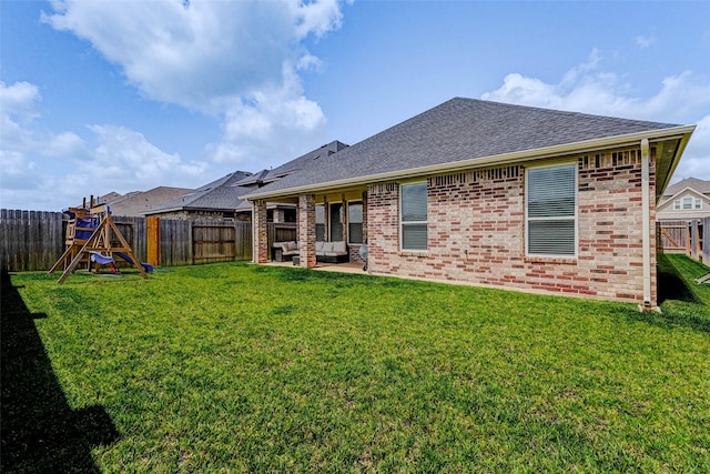3368 Voda Bend Dr, Katy, TX 77493 - back of property with a shingled roof, a patio area, brick siding, a fenced backyard, and outdoor lounge area